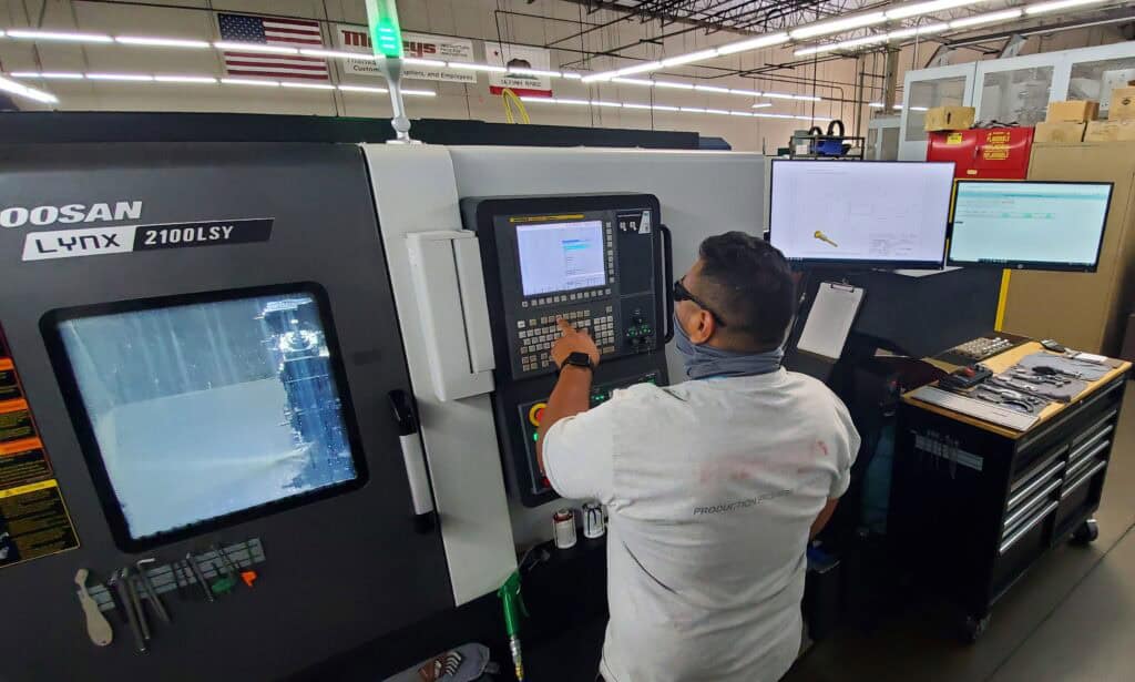 Machinist setting up CNC machine for operation