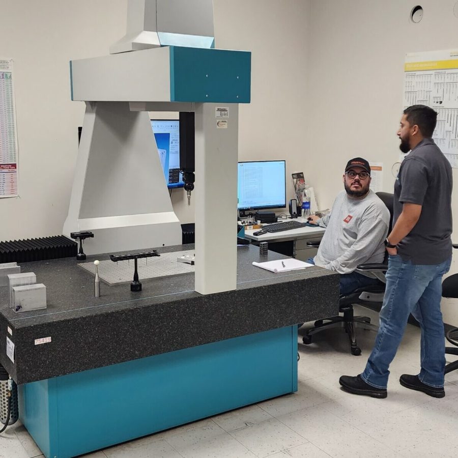 Inspection team training members to work with CMM (coordinate measurement machine)